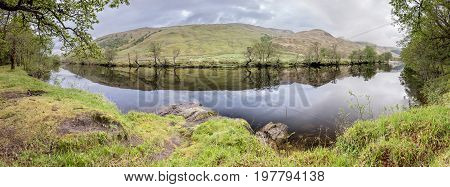 Trees reflecting on the river Orchy, Glen Orchy, Scotland, United Kingdom