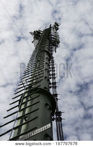 antenna supporting tower with white cloudy sky