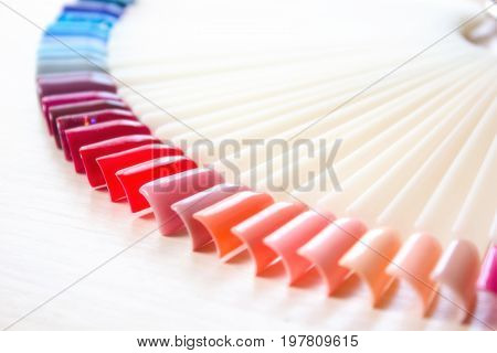 Samples of colored nail polish on a white table. Nail salon.