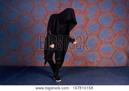 Young dancer dancing near the wall. Urban style