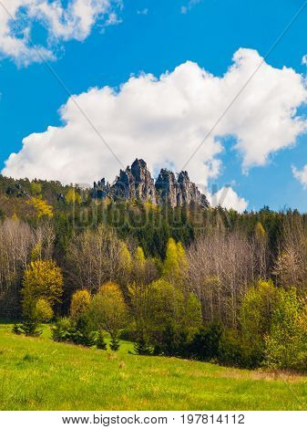 Monumental sandstone ridge of Suche Skaly, aka Dry Rocks, illuminated by summer evening sun near Mala Skala in Bohemian Paradise, Czech Republic.