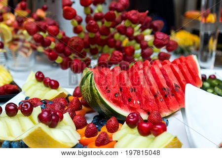 Heap of fresh fruits and vegetables on table close up.