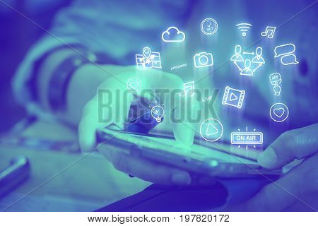 Close up woman using mobile phone with Live Streaming icon features Digital lifestyle conceptDuotone color filtered.