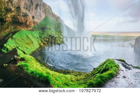 Seljalandfoss waterfall at sunset. Bridge over the river. Fantastic nature. Iceland. Europe