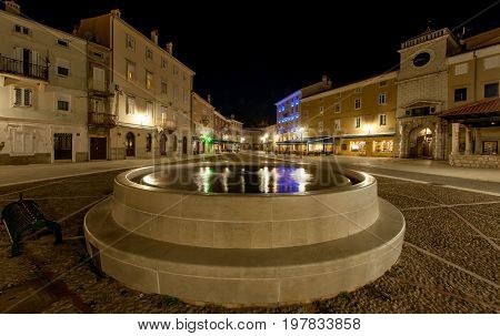 Fountain with reflection of lamps in the city of cres