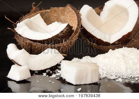 Halfs Of Coconut, Pieces Of Coconat, Coconut Flakes On Black Background.