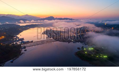 Aerial view and morning mist top view at Sangkhlaburi. It is a popular place for tourists. Images may be blurry due to fog.