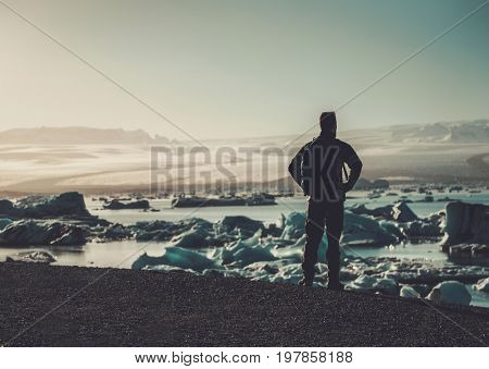 Man explorer lookig at Jokulsarlon lagoon, Iceland.