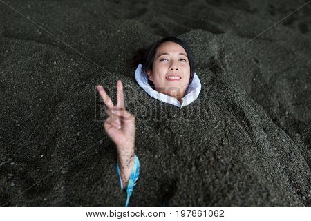 Woman enjoy hot sand bath in Japan