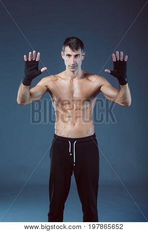 portrait of hand wrapping half nude boxer. Personal fitness instructor. Personal training.