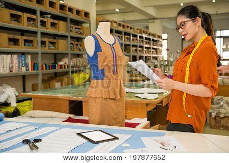 Apparel Company Employee Holding Draft Design