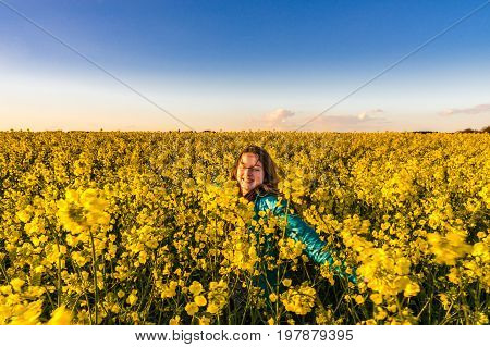 Teenage Girl With Long Hair In Yellow Bittercress Field