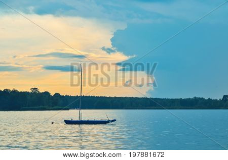 Boat on the water. Evening landscape by the lake.