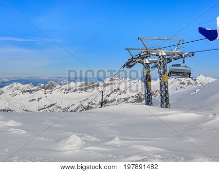 Overhead cable car on Mt. Titlis in Switzerland. The Titlis is a mountain located on the border between the Swiss cantons of Obwalden and Bern, mainly accessed from the town of Engelberg on the northern side.