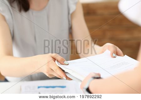Female employee show pack of documents to busy male manager or boss give extra work to executor. White collar portrait contract approval headache and depression irs lot of new problems concept