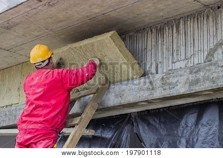 Man Installing External Wall Insulation