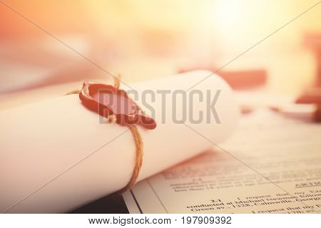 Notarial wax seal on tied scrolled documents, closeup