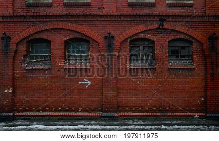 Big old brick wall with windows BW