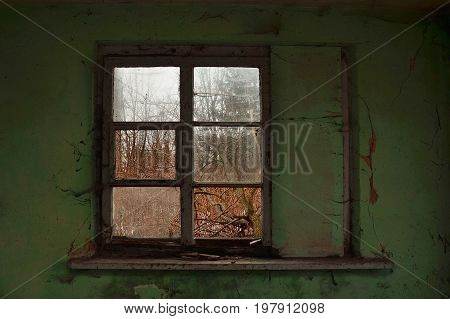 Old broken window with old painted green wall