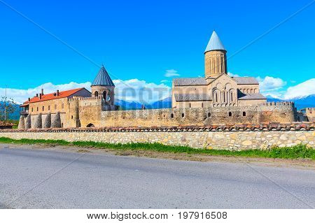 Panoramic view of Alaverdi orthodox monastery in Kakhetia region in Georgia and snow peaks of Caucasus mountains