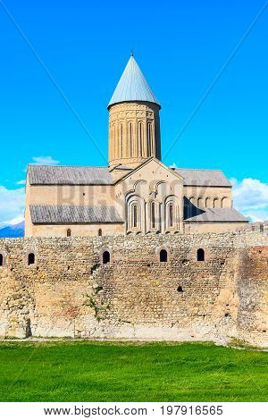 Alaverdi orthodox monastery in Kakhetia region in Georgia and snow peaks of Caucasus mountains