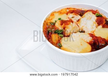Baked vegetables zucchini and tomatoes with cheese. Isolated on white by clipping path. Close up