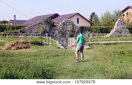 Tourist visiting ruins at Curtea Domneasca, Curtea de Arges, Romania