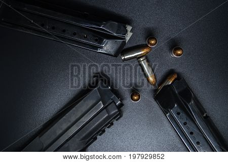 9 mm Pistol, bullets and magazine on black background. Gun isolated
