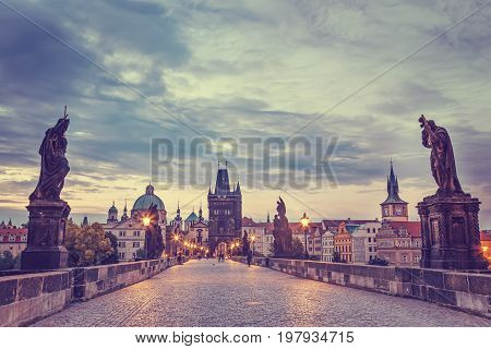 View of Charles Bridge in Prague with blue sky and clouds Czech Republic during blue hour sunrise.