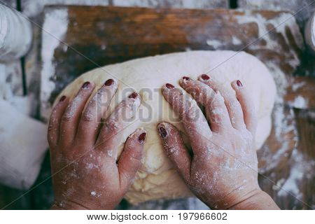 Close Up View Of Baker Kneading Dough. Homemade Bread. Hands Preparing Bread Dough On Wooden Table.