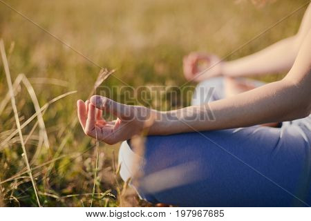 Woman Practices Yoga And Meditates In The Lotus Position On The Nature.  Girl Meditate At The Mounta