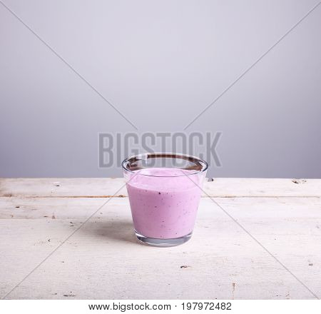 Yogurth with fresh berries on white table
