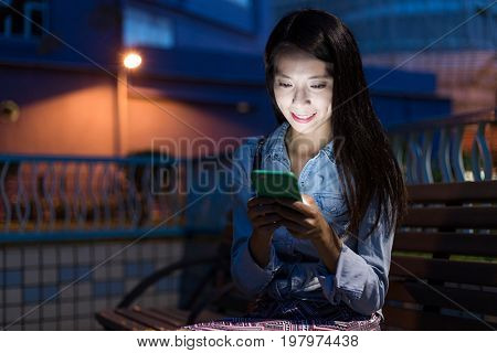 Woman looking at mobile phone at outdoor