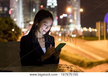 Business woman working on cellphone in Hong Kong city