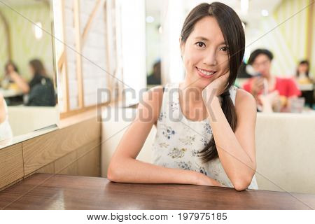 Woman inside restaurant and waiting for food