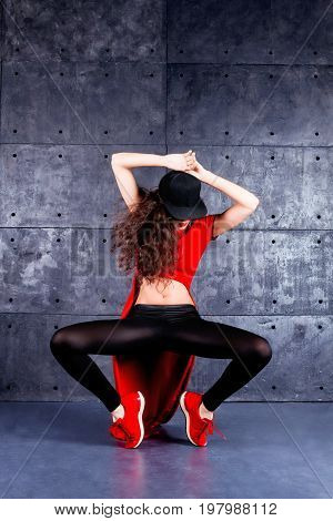Girl dancing in front of the urban wall.