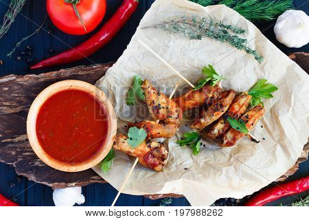 Grilled Chicken Wings With Spicy Tomato Sauce On Craft Paper Ser