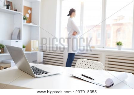 Background Image Of Doctors Office With Woman Standing At Window Copy Space