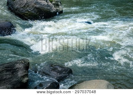 Wild River Water Stream Between Big Granite Rock. Rivulet Water Flowing Rushing By Big Stone Boulder
