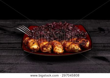Fried Homemade Grilled Sausages Or Chevapchichi With Stewed Sauerkraut On A Wooden Rustic Background