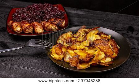 Fried Homemade Grilled Sausages Or Chevapchichi With Stewed Sauerkraut On A Wooden Rustic Background