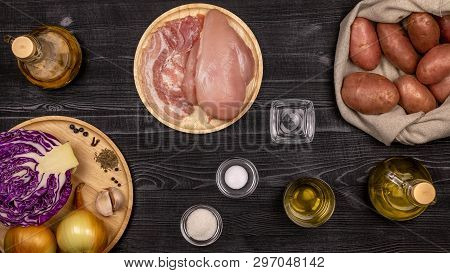 Fresh Ingredients For Cooking Fried Potatoes, Stewed Cabbage And Grilled Sausages Or Chevapchichi Ba