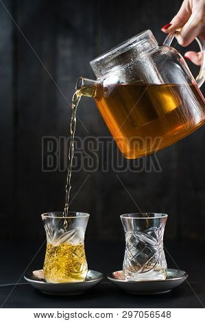 The Girl Pours Tea In An Armud.