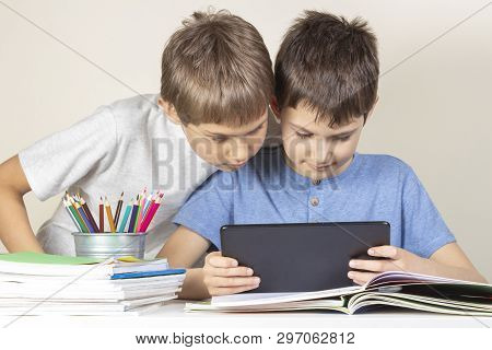 Kids Using Together Tablet Computer At Home