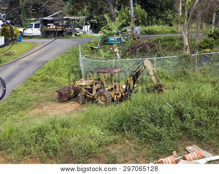 Cerro Gordo, Bayamon/puerto Rico - February 22, 2019: Rusted Ford Holland Case Loader Tractor Backho