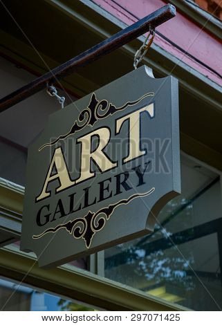 Wooden suspended art gallary sign.
