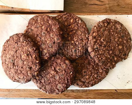 Chocolate Chip Cookies For Sale On Paper With Wooden Surface.