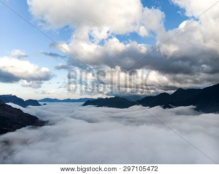 Abstract Landscape Photograph, Mountains Shrouded In Clouds. Fog Floating Between Mountain Peaks, Ch