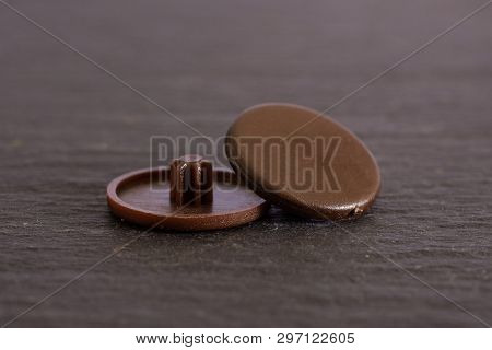 Group Of Two Whole Brown Plast Plugs Work Item On Grey Stone