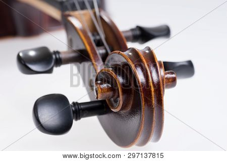 Scroll Of The Classical Violin On White Background. Head Of Vintage Violin Over White Background